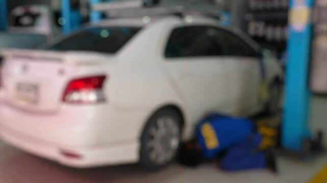 Mechanic working on car in auto repair shop, ensuring vehicle maintenance and safety. Automobile Repair and Maintenance.