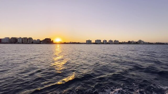 Larnaca Cyprus, view from the boat of the coast at sunset. Hotels and buildings on the beach in Larnaca. Boat ride in Cyprus. Boat tour to the Zenobia shipwreck.