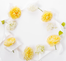 Square festive frame of yellow roses and white hydrangeas with white ribbon. Congratulatory wedding autumn background