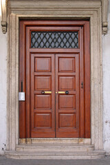 Obraz premium Brown Wood Double Doors With Silver Intercom House Entrance in Rome Italy
