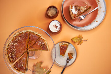 pumpkin pie, pumpkin pie slices on a peach background top view