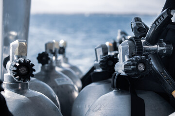 Row of Scuba Diving Tanks by the Sea