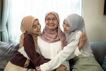 Muslim mother Hugging Two Her Daughters