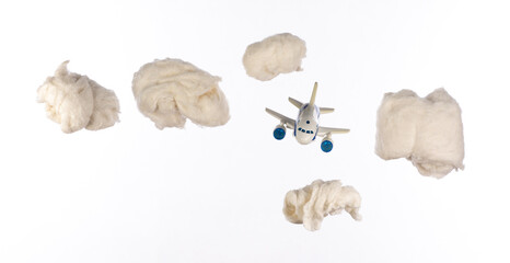 toy airplane flies in cotton wool clouds