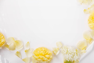 Square festive frame of yellow roses and white hydrangeas with white ribbon. Congratulatory wedding autumn background