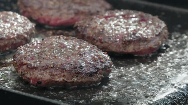 Cooking hamburger patties outside 