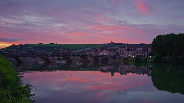 Twilight time illumination Joigny city famous. Yonne riverside downtown panorama. Sunset view of river
