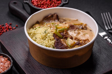 Bowl of food with beef, bulgur, tomatoes, zucchini and sauce