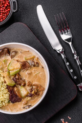 Bowl of food with beef, bulgur, tomatoes, zucchini and sauce