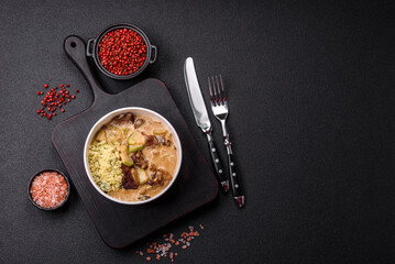 Bowl of food with beef, bulgur, tomatoes, zucchini and sauce