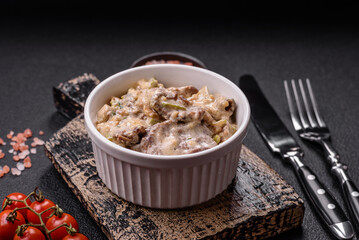 Bowl of food with beef, bulgur, tomatoes, zucchini and sauce