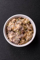 Bowl of food with beef, bulgur, tomatoes, zucchini and sauce