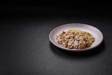 Bowl of food with beef, bulgur, tomatoes, zucchini and sauce