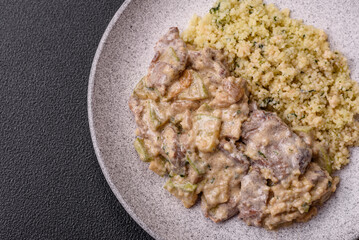 Bowl of food with beef, bulgur, tomatoes, zucchini and sauce