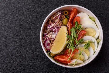 Salad with tuna pieces, boiled egg, cherry tomatoes, lettuce