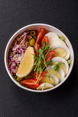 Salad with tuna pieces, boiled egg, cherry tomatoes, lettuce