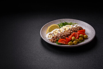 Salad with tuna pieces, boiled egg, cherry tomatoes, lettuce