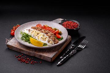 Salad with tuna pieces, boiled egg, cherry tomatoes, lettuce