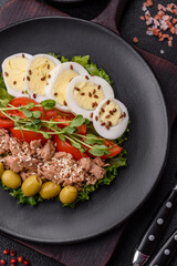 Salad with tuna pieces, boiled egg, cherry tomatoes, lettuce