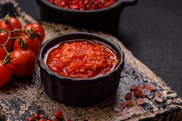 Delicious hot spicy red sauce with salt and spices in a ceramic bowl