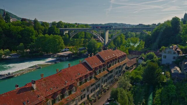 Bern medieval old town with a tramway and traditional red roofsdriving on the Kirchenfeld bridge above the Aar river in Switzerland capital city
