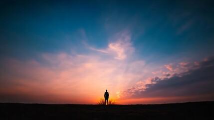 A lone figure of Moses is highlighted by a fiery bush in the distance, surrounded by a barren landscape and a captivating blend of blue and gold hues