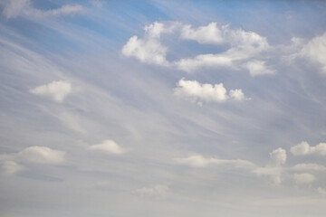 White puffy clouds and celestial haze in the blue sky, celestial landscape with haze