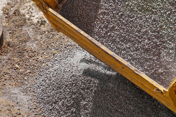 Close-up of crushed stone unloading at a construction site - detailed image of the process of...