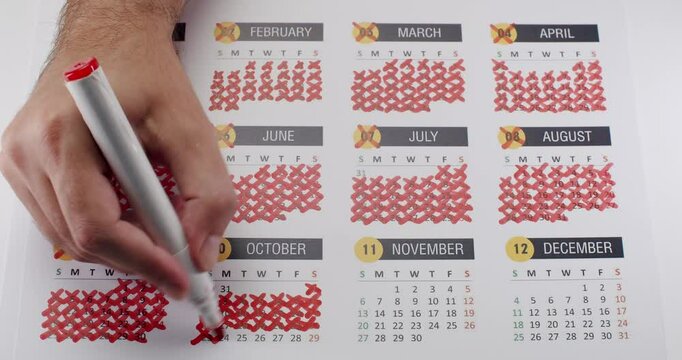 Close-up of a hand using a red marker to cross out days on a calendar, symbolizing time management, countdown, or end of the year. Hand Marking Days on a Calendar with Red Marker Next to December - Powered by Adobe