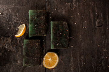 Handmade Green Soap Bars With Citrus Slices on Rustic Wood