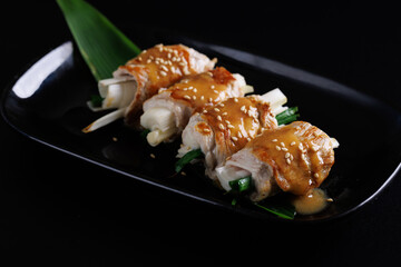 japanese pork roll grill japanese food isolate in black background