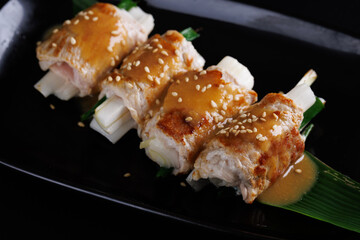 japanese pork roll grill japanese food isolate in black background