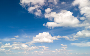 Beautiful blue sky filled with fluffy white clouds creating a serene and peaceful atmosphere, perfect for backgrounds or nature themes.