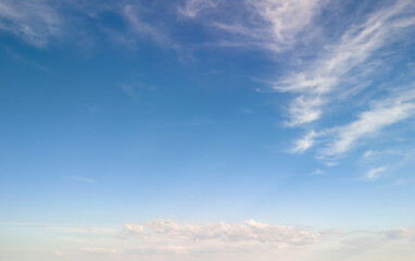 A beautiful blue sky with wispy clouds, perfect for backgrounds or nature-themed projects.