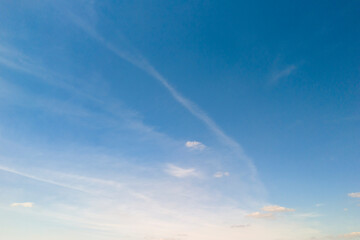 A clear blue sky with wispy clouds, perfect for backgrounds or designs. Ideal for nature-related projects and serene themes.