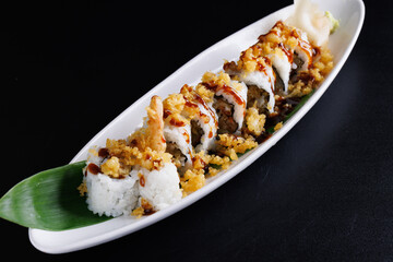 Tempura shrimp maki roll with cucumber Japanese food isolate in black background