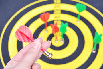 Female hand holding darts and aiming for victory . Hit the sector in darts. The concept of...