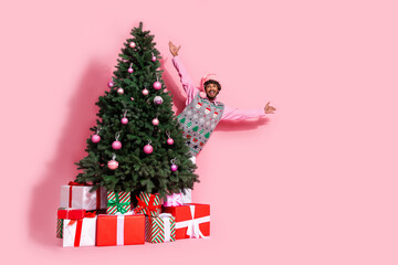 Full length photo of cheerful positive guy dressed ornament vest santa headwear enjoying x-mas eve emtpy space isolated color background