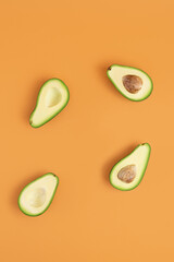 Avocado on a pastel orange background. Creative food concept. Minimal layout, top view