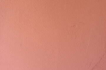Minimalist textured pink wall under soft lighting