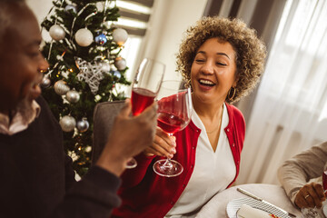 African American family drinking wine at the Thanksgiving, Christmas dinner.