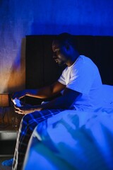 Bad Sleep. Portrait Of Black Guy Waking Up At Night Sitting In Bed In Bedroom At Home. Tired Man Having Headache And Insomnia Problem, Can't Fall Asleep. Sleeplessness Concept