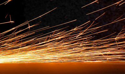 iskry, pomarańczowe iskry, iskry ze szlifierki, orange sparks, sparks from the grinder, Sparks from cutting metal of angle grinder, spark from the grinding wheel  © kateej