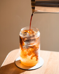 pouring coffee into tonic water 