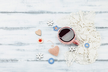 A cup of fragrant hibiscus tea and cute handmade decor. Good mood concept, cozy home comfort