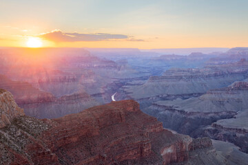 Aerial view of Grand Canyon at sunset with dramatic sky and red rocks, Arizona, United States.