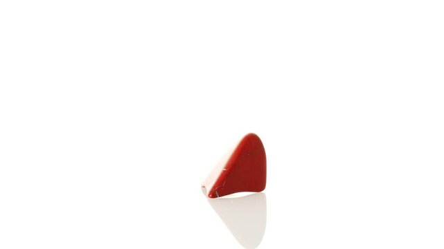 mineral stone red jasper rotates in a circle on a white background