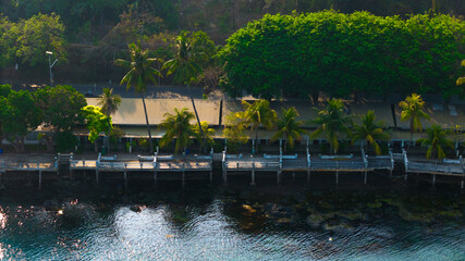 Serene tropical waterfront with lush greenery and tranquil waters inviting peaceful reflection at dusk