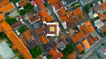 Aerial view showcasing the geometric beauty of a colorful urban neighborhood with a mosque at its heart