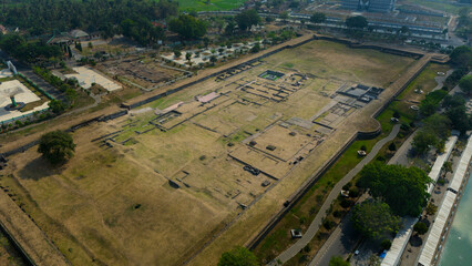 Aerial view showcasing the intricate layout of an ancient archaeological site bordered by modern development